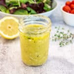 A yellow salad dressing in a glass canning jar.
