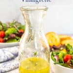 A bottle filled with a lemon salad dressing.