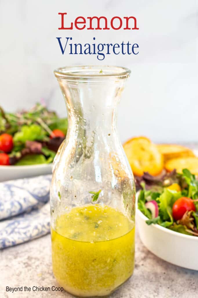 A bottle filled with a lemon salad dressing.