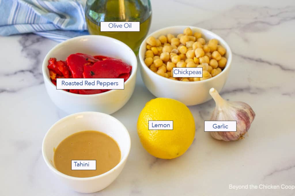 Small bowls filled with ingredients for making hummus.