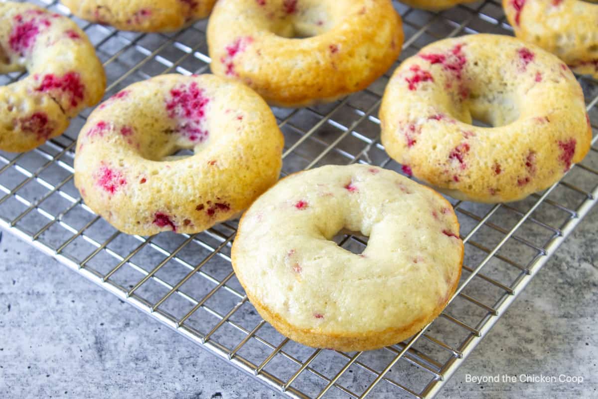 Baked donuts on a baking rack.