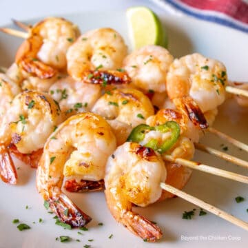 Skewered shrimp on a plate.
