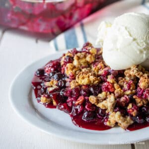 A huckleberry dessert topped with a scoop of ice cream.