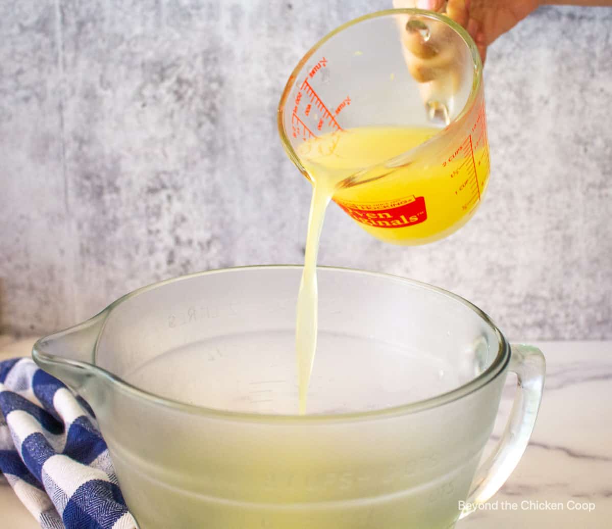 Lemon juice being poured into a bowl.