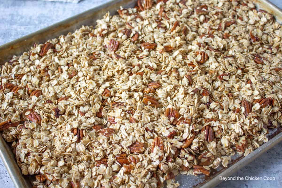 A cookie sheet filled with granola.