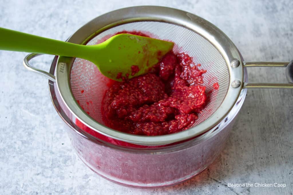 Raspberry seeds left in a sieve.