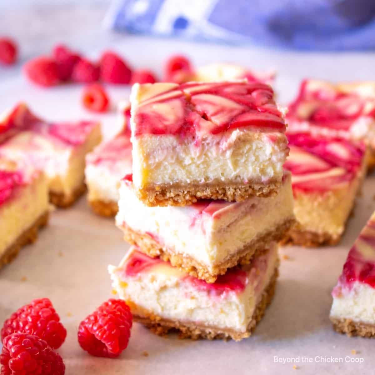 Three cheesecake bars stacked on top of each other.
