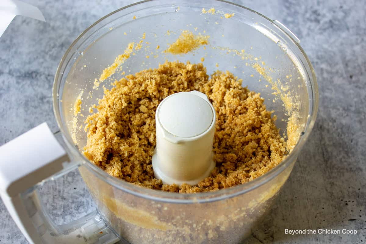 Coarse crumbs for making a crust in a food processor bowl.
