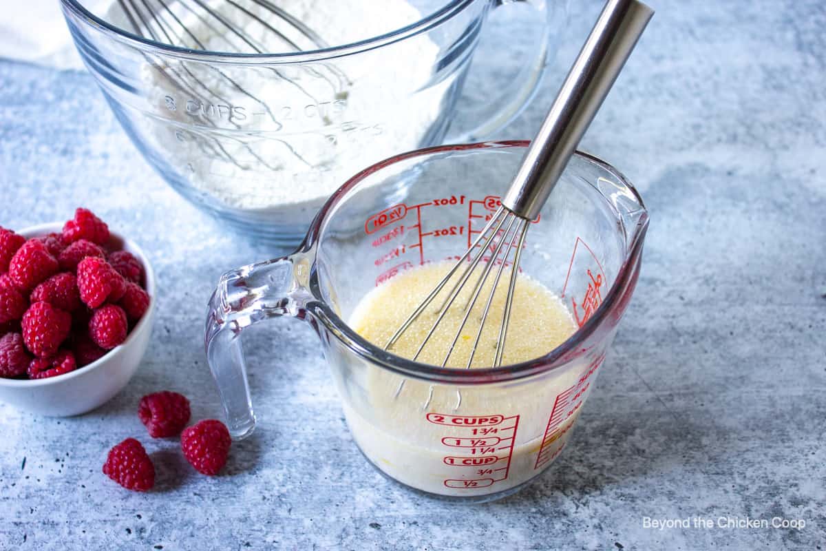 Milk and oil in a glass measuring cup.