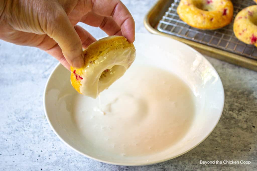 A donut dipped into a white glaze.