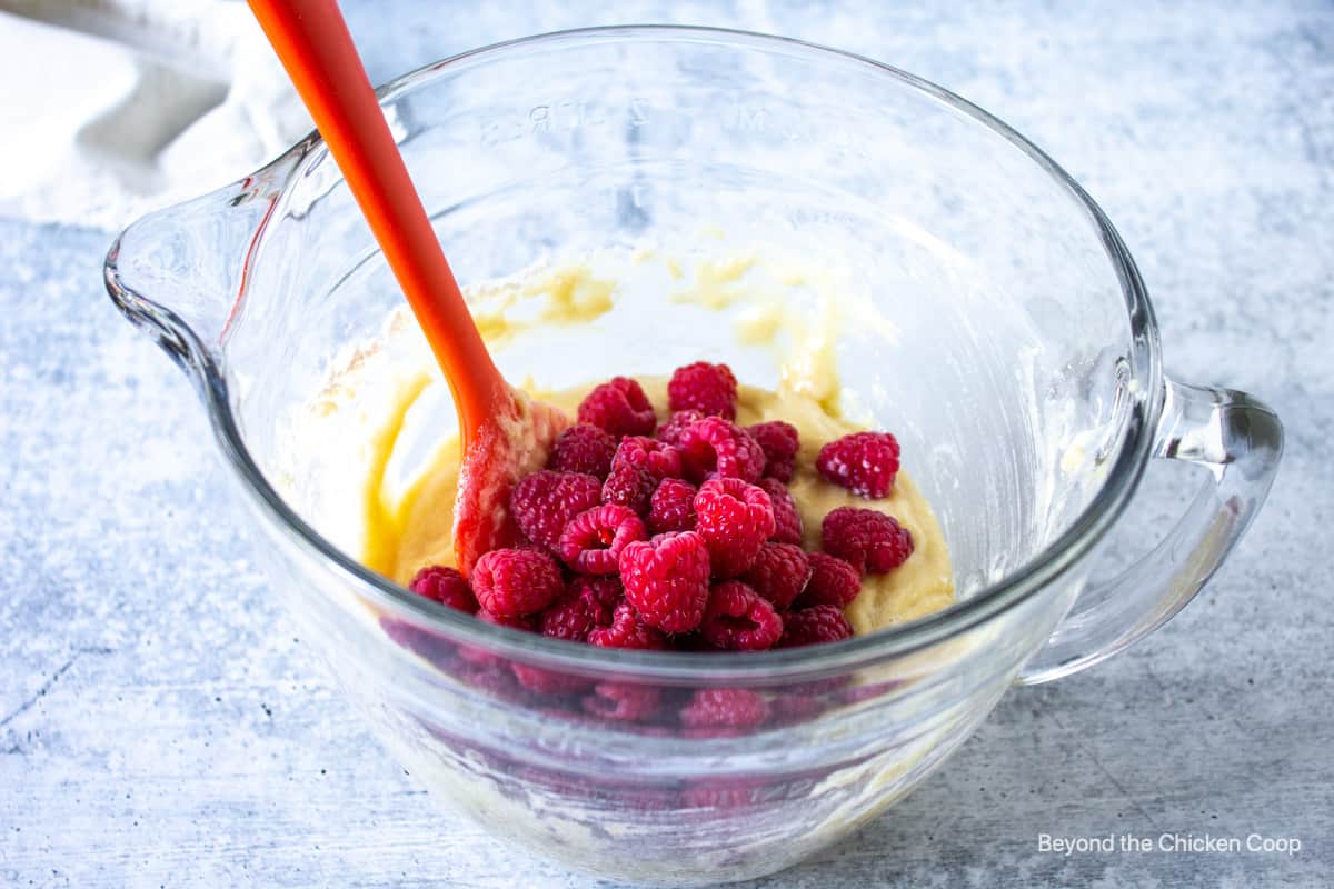 Fresh raspberries added to a batter.