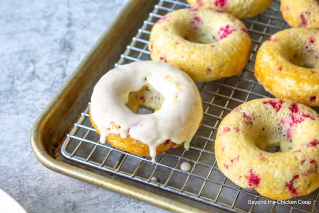 Donuts on a baking rack.