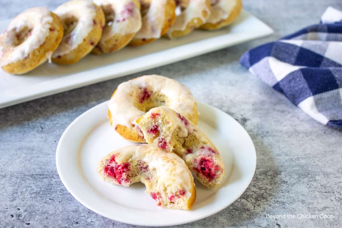 Raspberry donuts on a white plate.