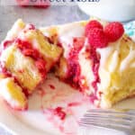 Sweet roll filled with raspberries and topped with fresh raspberries.