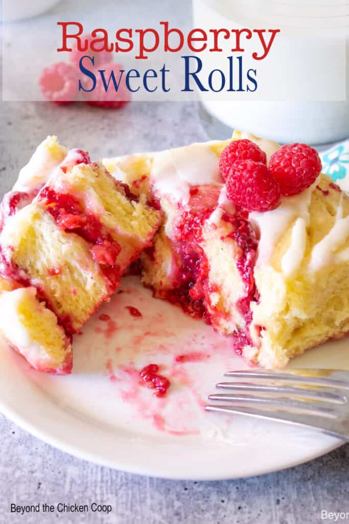 Sweet roll filled with raspberries and topped with fresh raspberries.