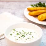 A bowl filled with a thick white sauce.