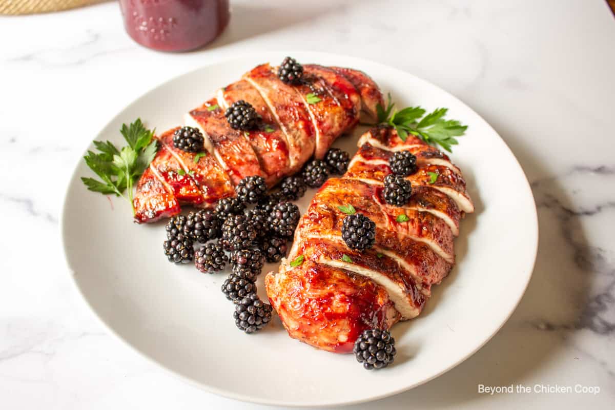 Grilled chicken breast topped with fresh blackberries and a BBQ sauce.