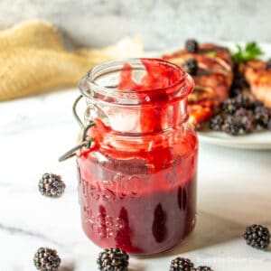 A jar filled with blackberry BBQ sauce.