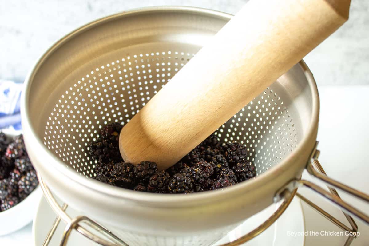 Blackberries in a chinois strainer.