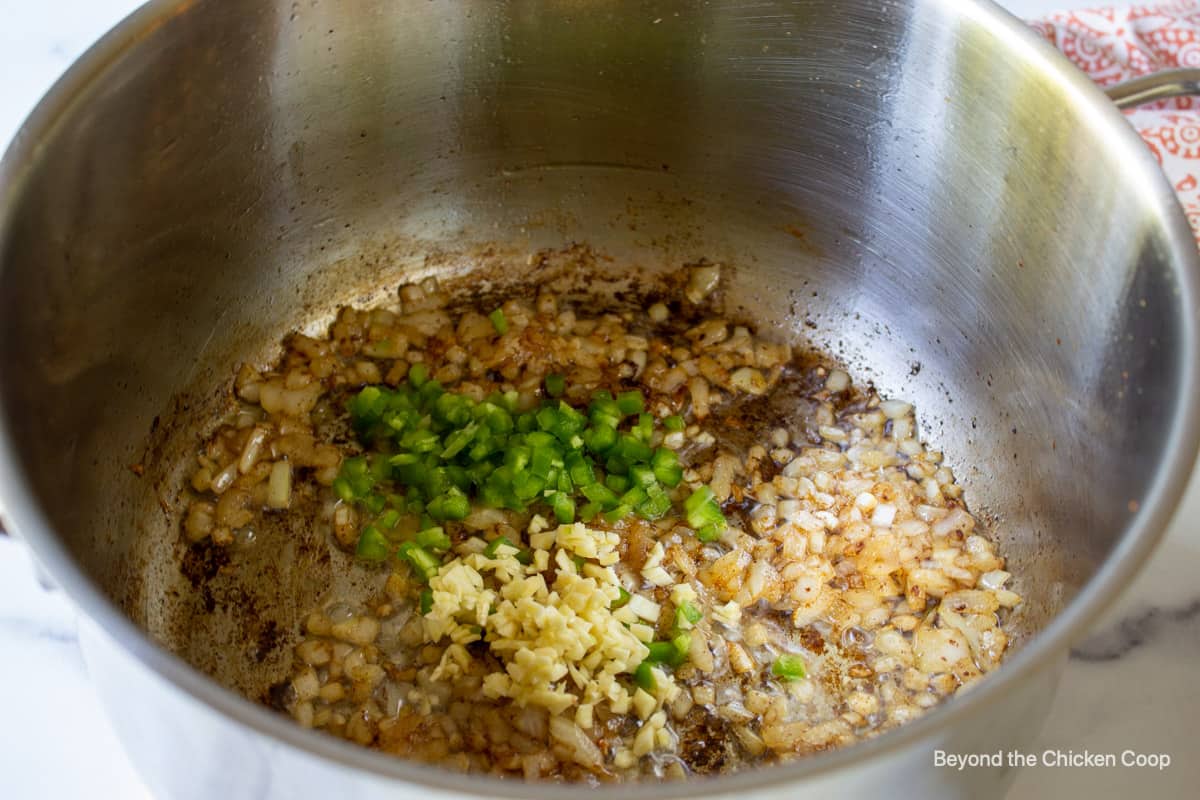 Onions, garlic and chopped jalapenos in a stock pot. 