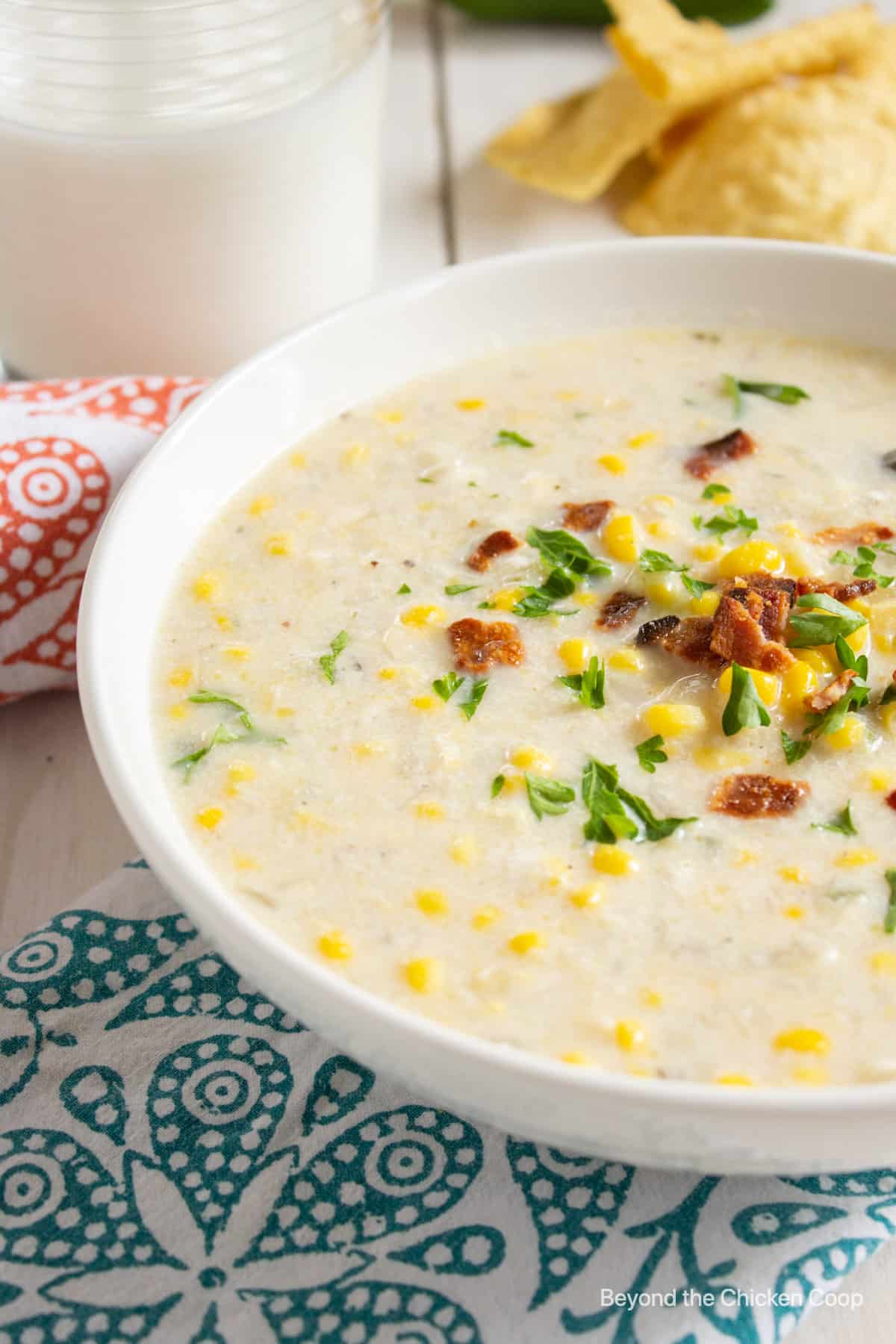 A creamy soup with corn and bacon and green herbs.