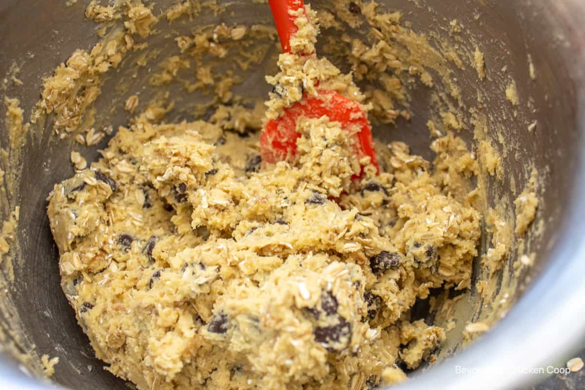 Cookie dough in a bowl with a spatula.