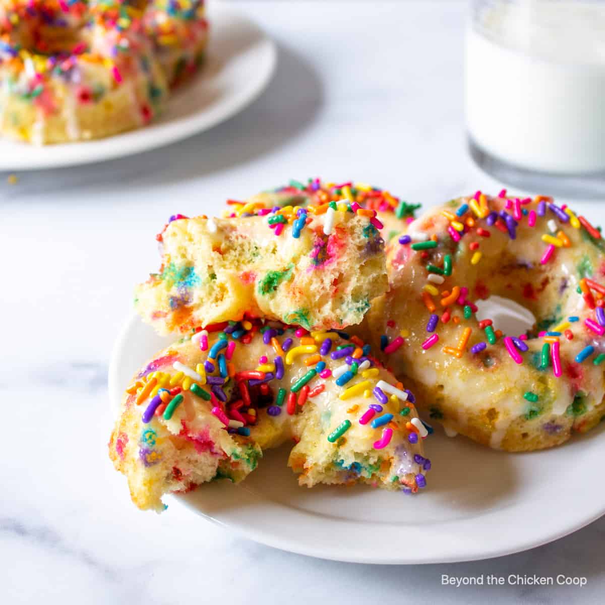 Baked donuts covered with colorful sprinkles.