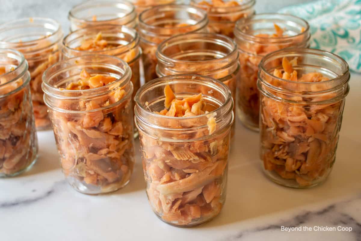 Canning jars filled with smoked fish.