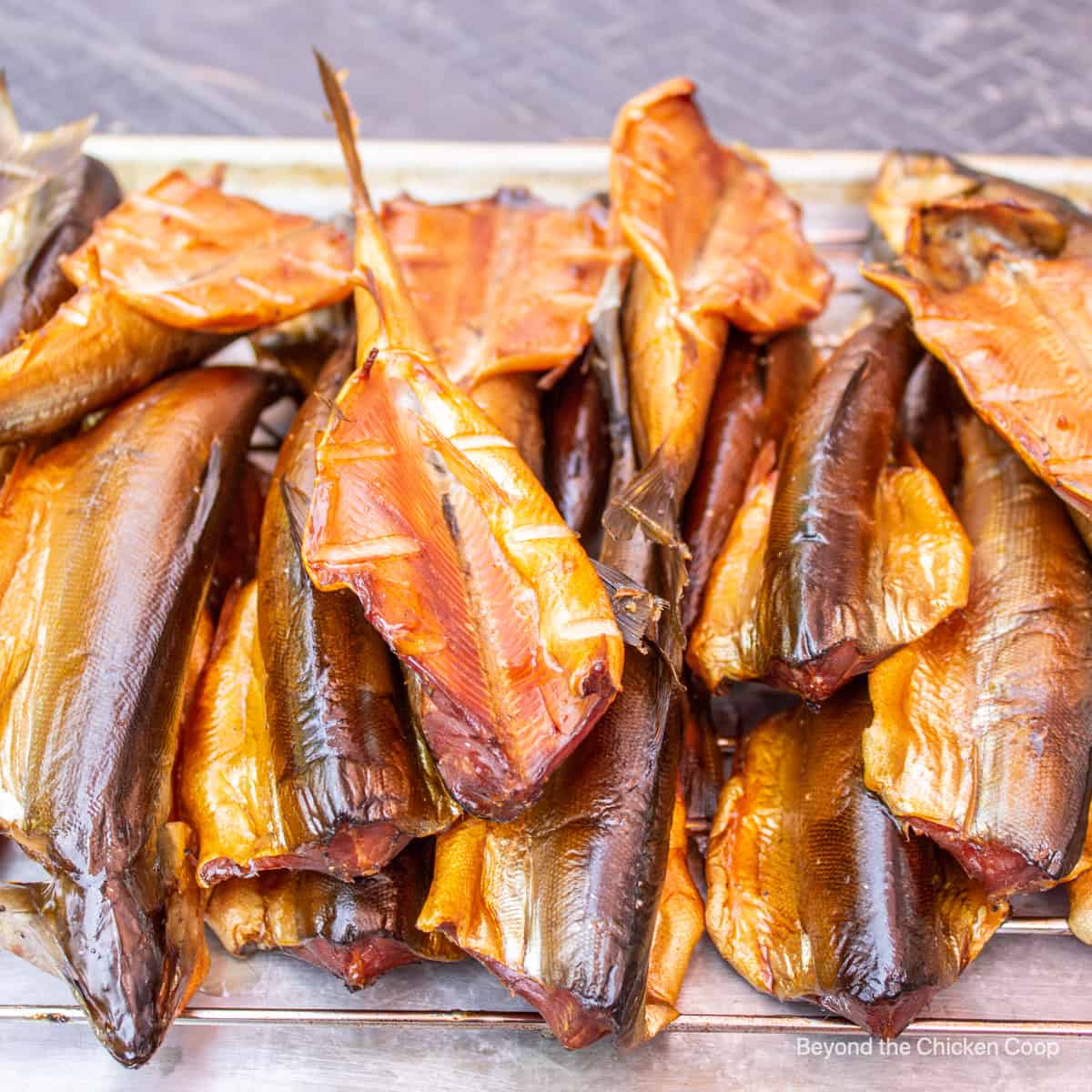 Smoked fish piled on a rack.