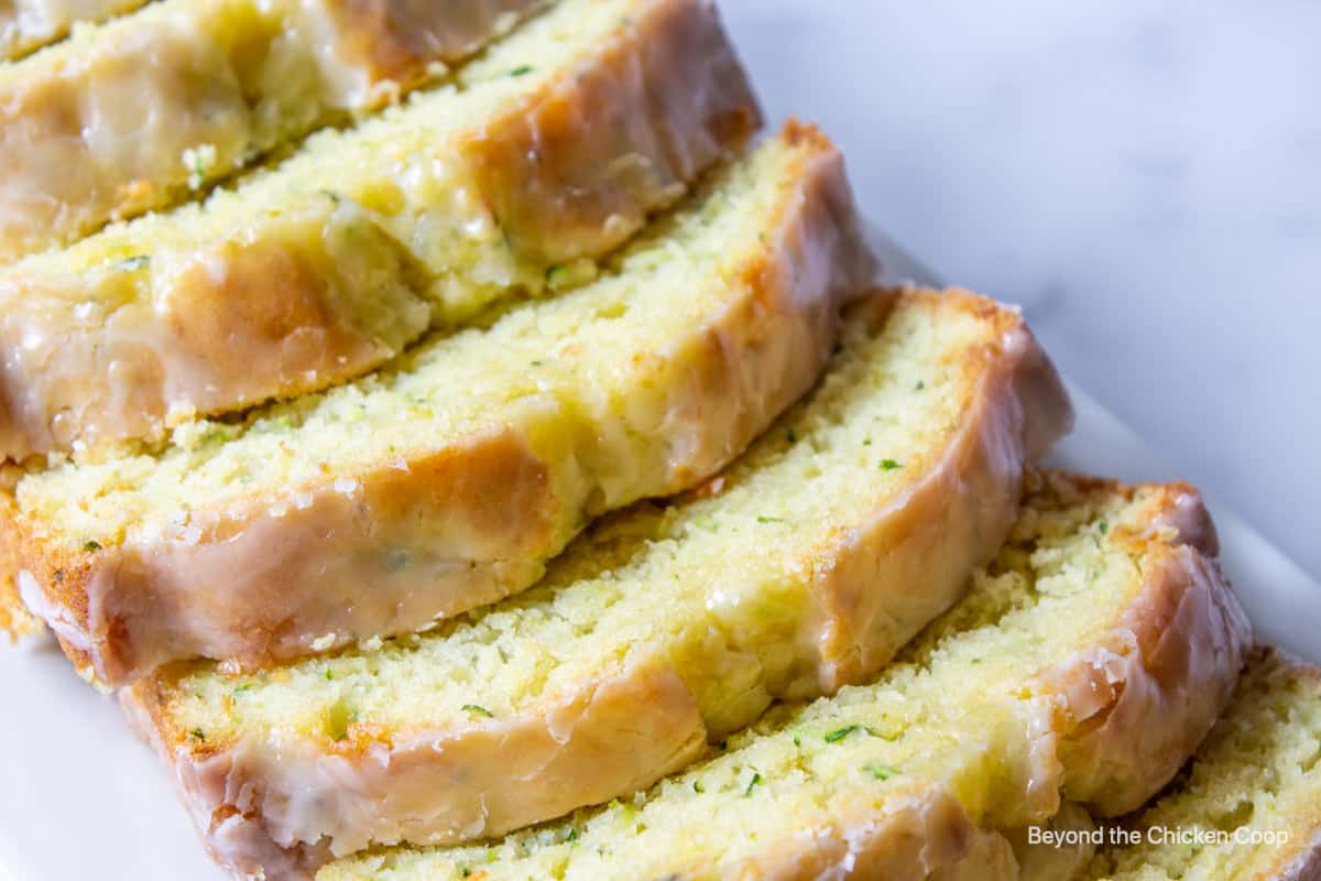 Sliced zucchini bread with a glaze.