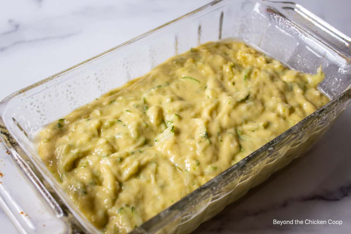 Zucchini bread batter in a loaf pan.