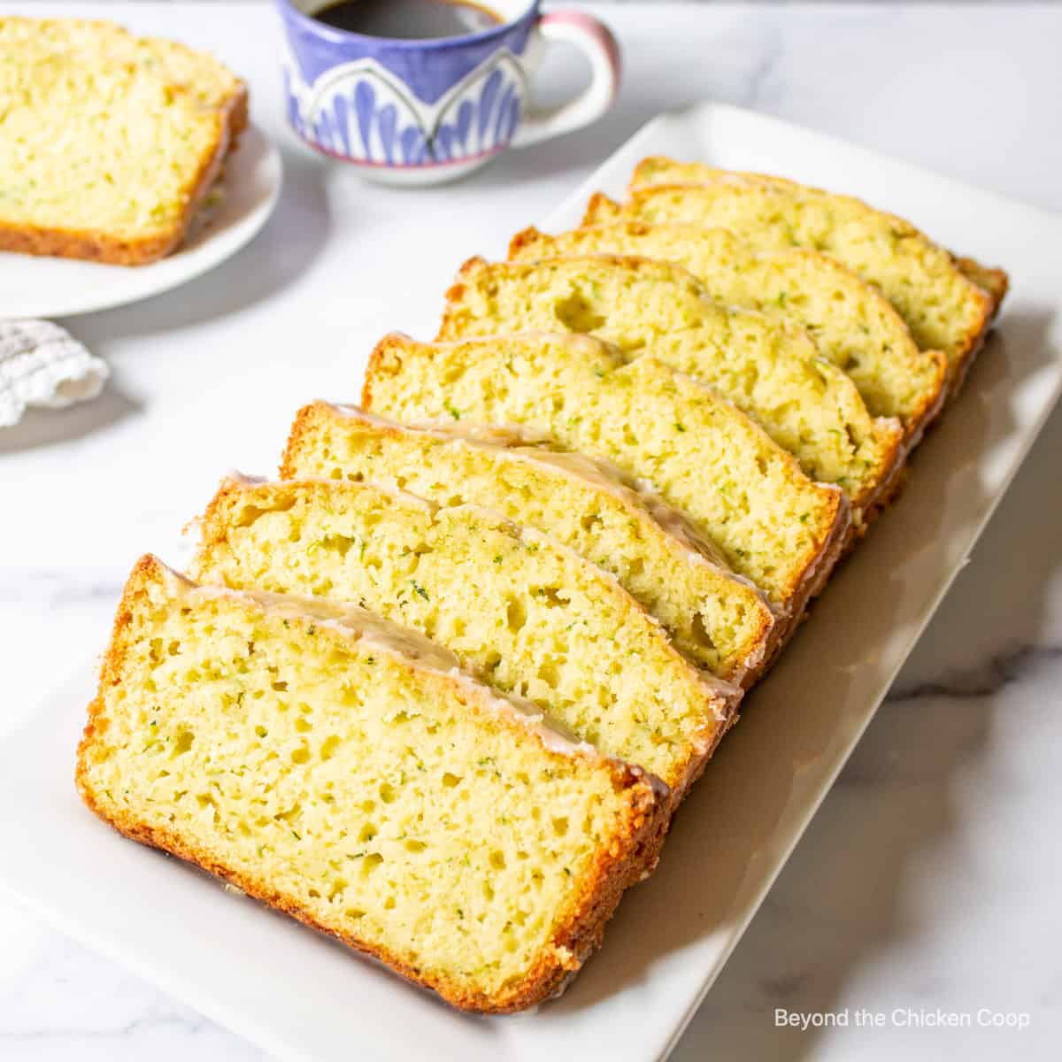 Slice zucchini bread topped with a lime glaze.