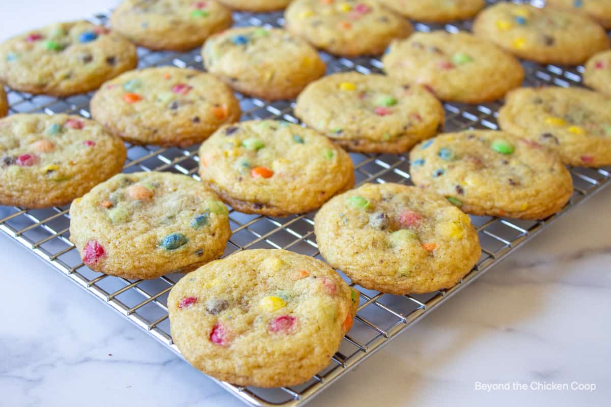 M and M cookies on a baking rack.