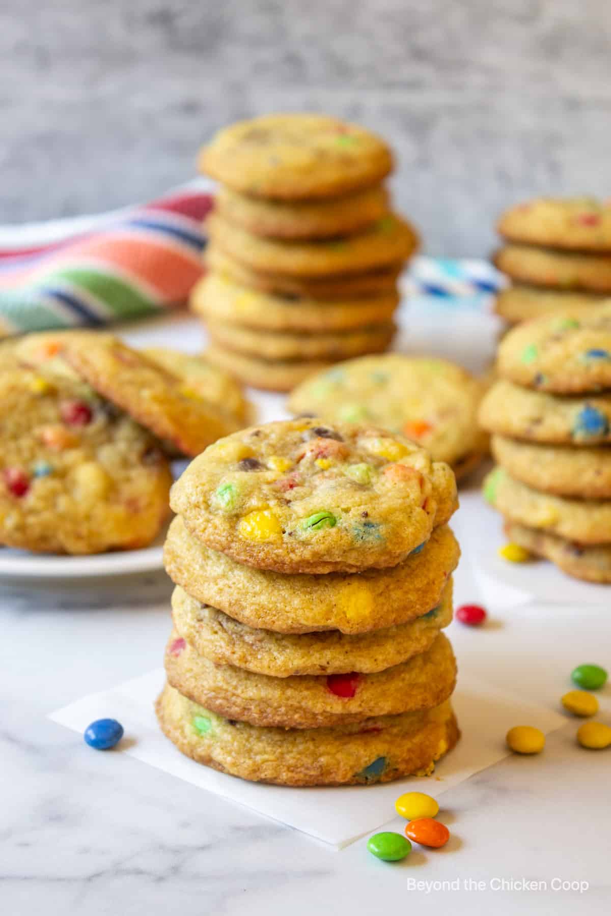 A stack of cookies filled with candy pieces. 