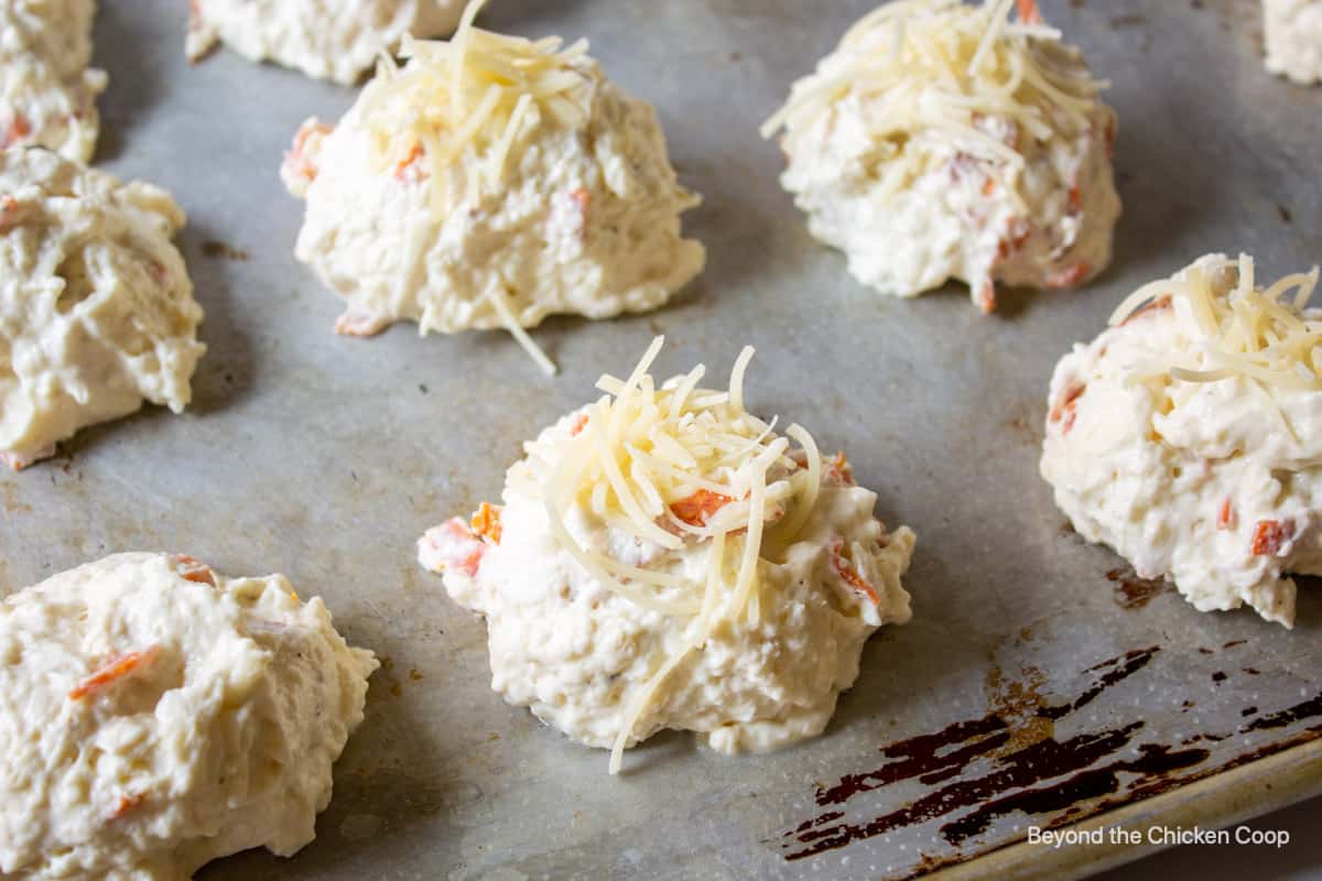 Mounds of dough topped with parmesan cheese.