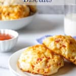 Two biscuits on a white plate.