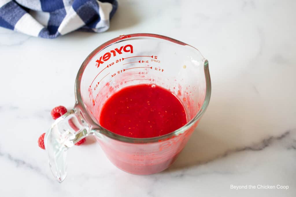 Pureed raspberries in a glass.