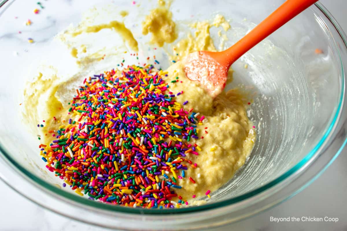 Colorful sprinkles added to donut batter.