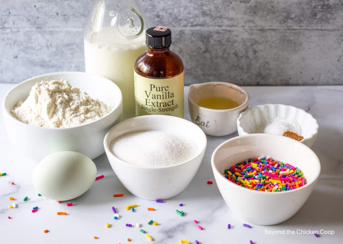 Ingredients for making baked funfetti donuts.