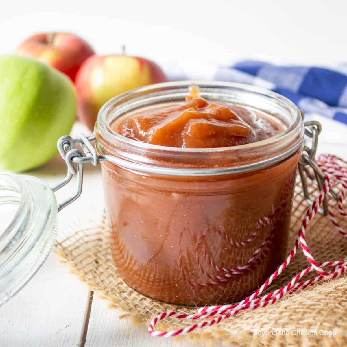 A glass crock filled with brown apple butter.