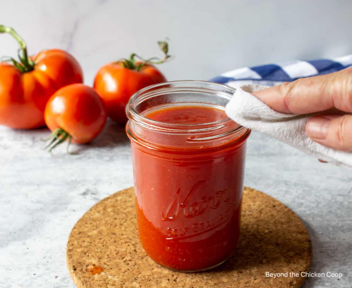 Cleaning the rim of a canning jar.