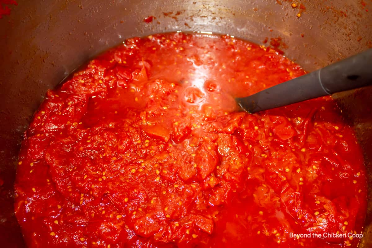 Cooked down tomatoes in a large pot.