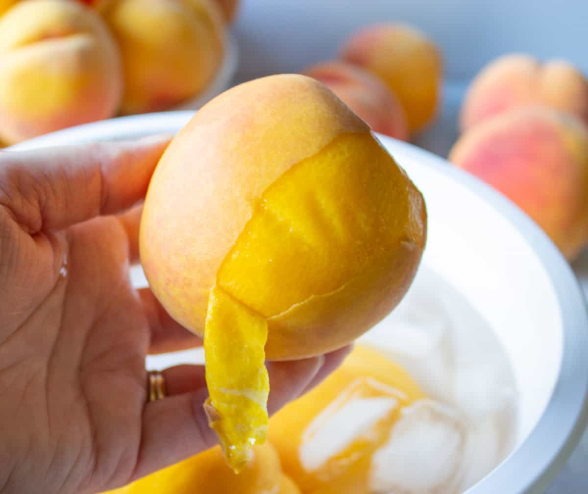 Removing the skin from a peach.