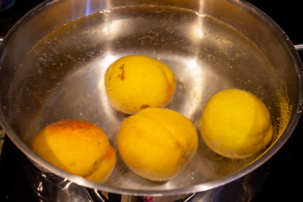 Peaches in a a hot water bath.