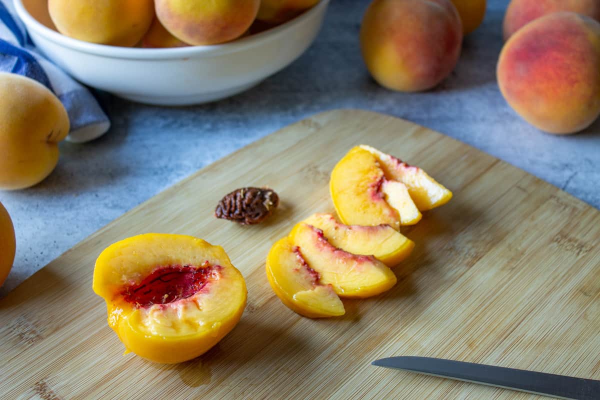 A peach cut in half with the pit removed.