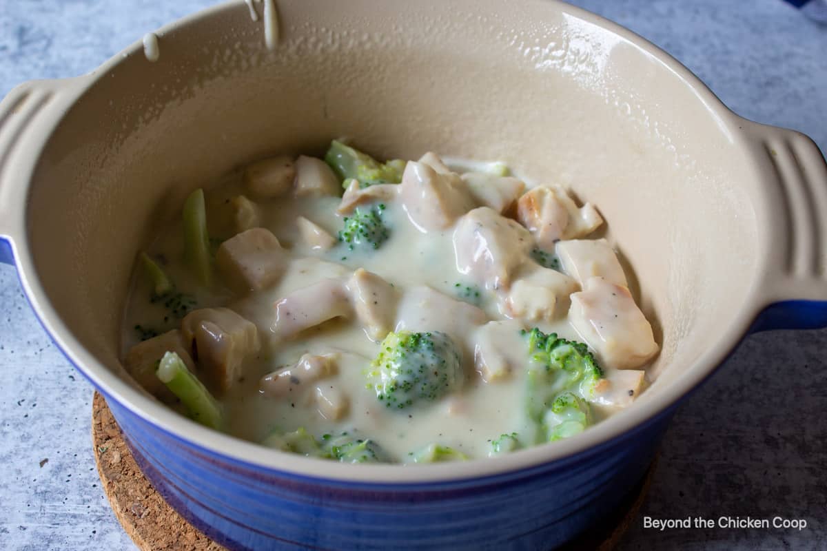A casserole dish with chicken and broccoli.