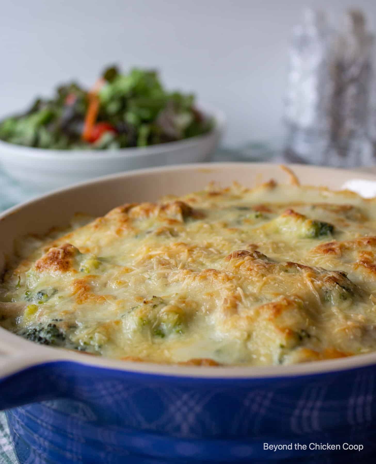 A blue casserole dish filled with a chicken casserole.