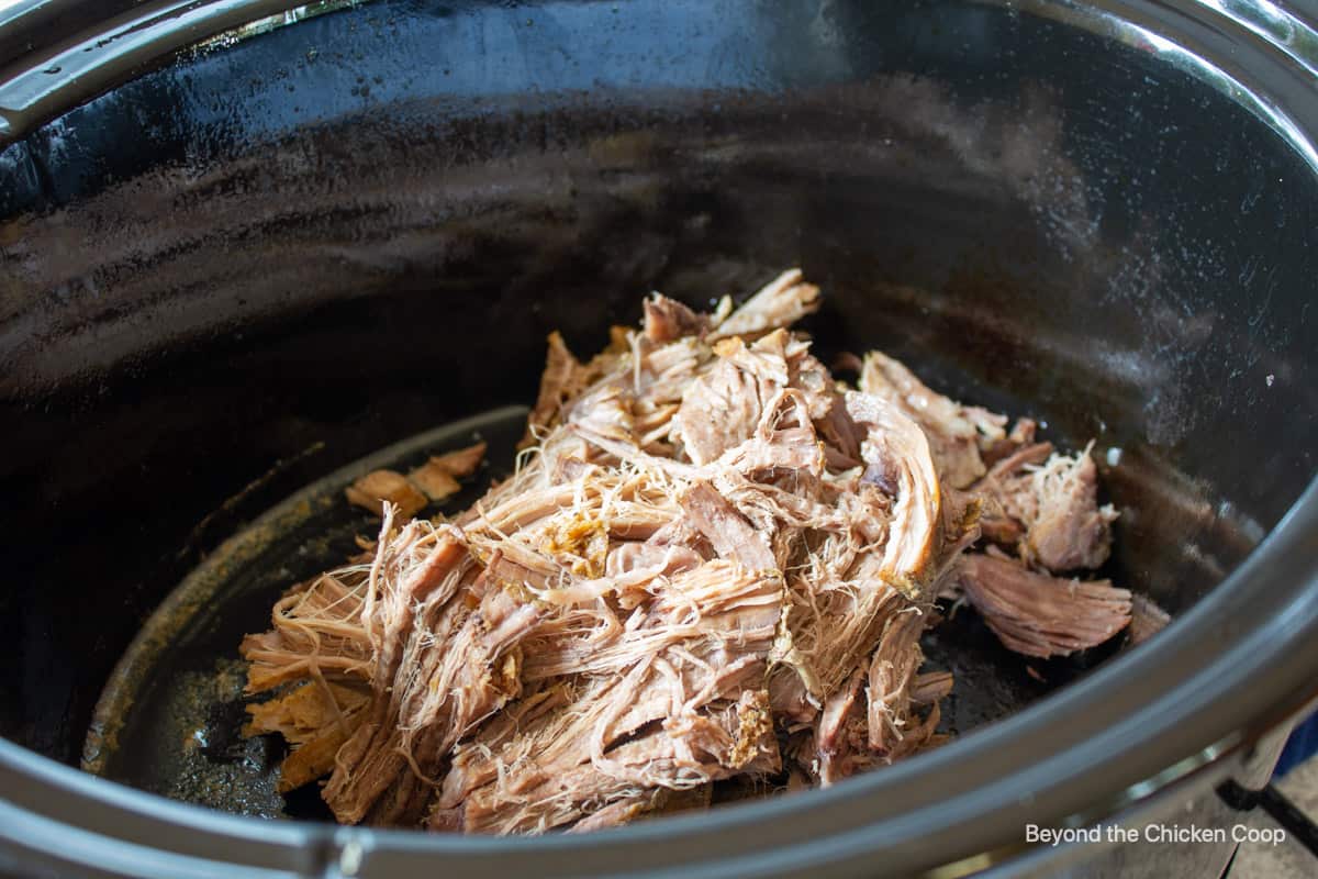 Shredded pork in a slow cooker.