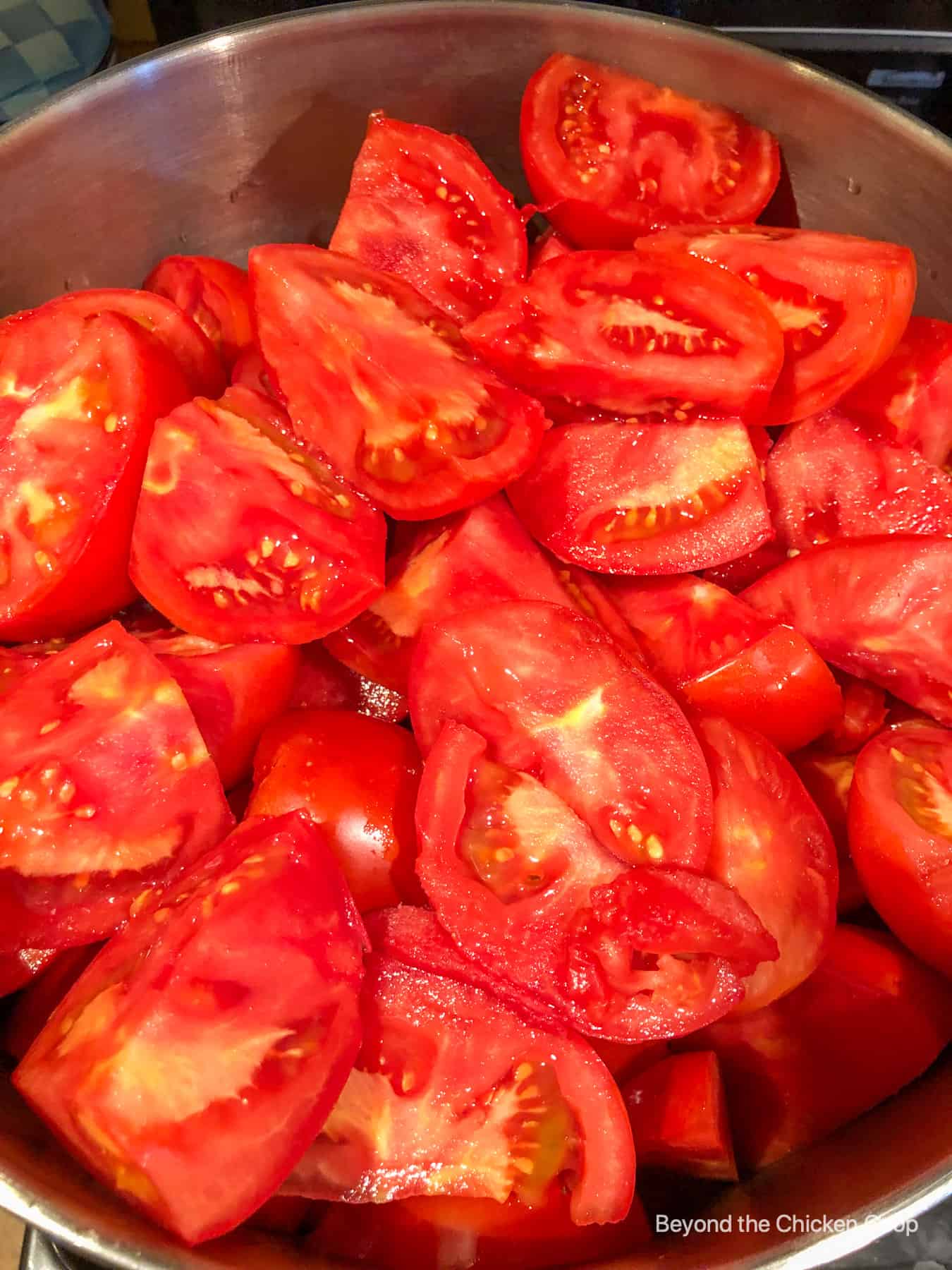 Chopped tomatoes in a pot.