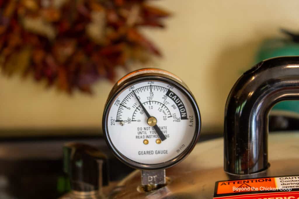A pressure gage on top of a pressure canner.